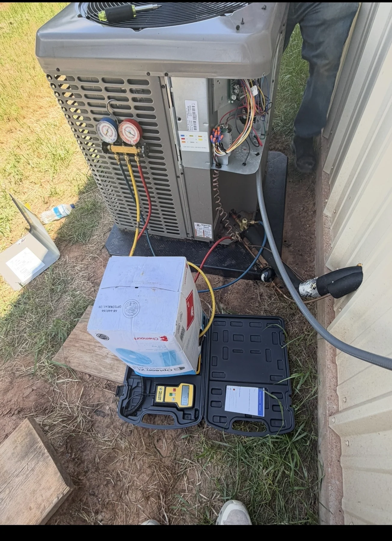 HVAC system being diagnosed with gauges and service tools